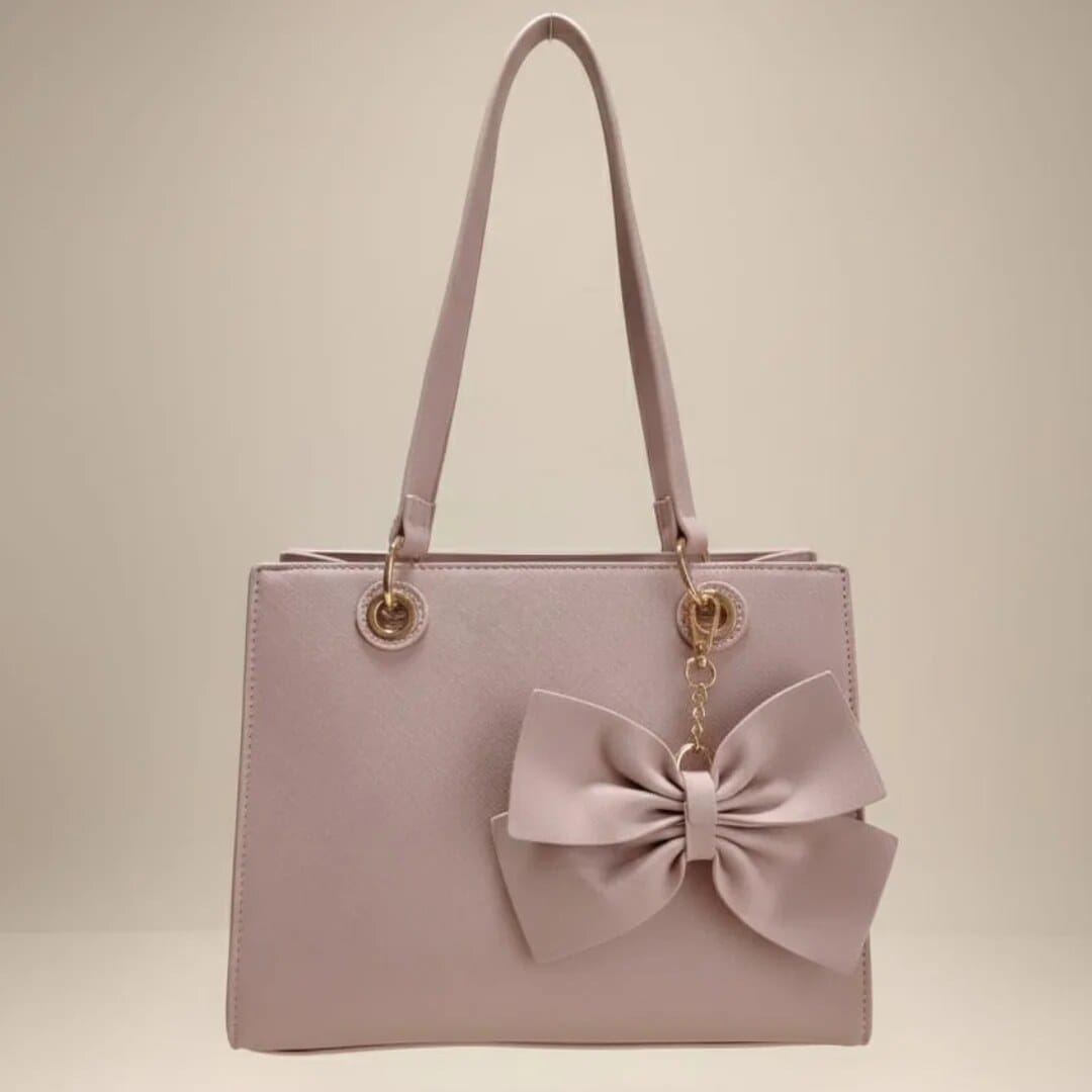 Bolso rosa palo con lazo y herrajes dorados