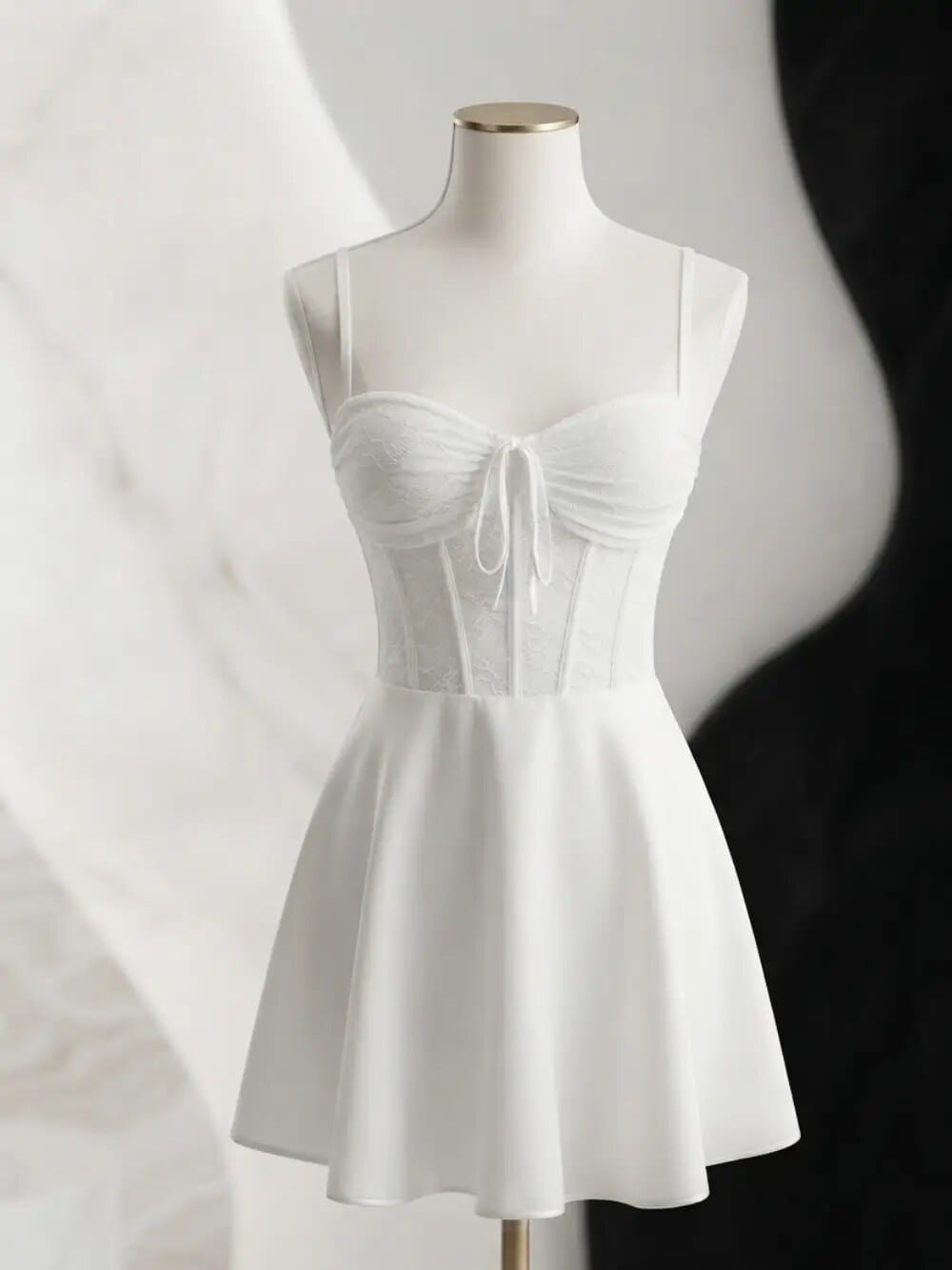 Vestido blanco corto con corsé de encaje sobre maniquí
